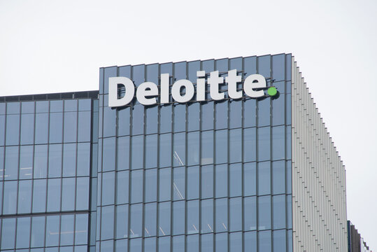 Adelaide, South Australia - April 24 2026: corporate office building showcasing a prominent Deloitte. business logo against a clear sky, representing global finance