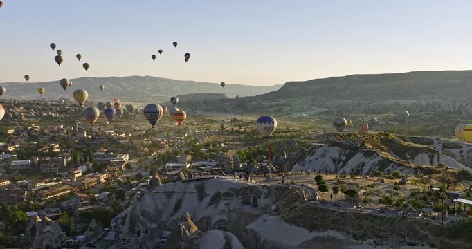 G�reme Turkey Aerial v69 low level drone fly around plateau view point capturing panoramic Cappadocia landscape with colorful hot air balloons flying in the sky - Shot with Mavic 3 Cine - July 2022