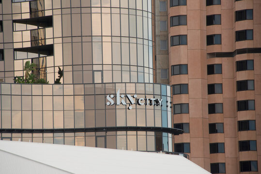 Adelaide, South Australia - April 24 2026: glass facade Skycity contemporary building reflecting the sky next to a traditional brown high-rise