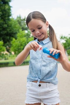 Joyful moments of childhood as a little girl plays with bubbles in a sunny park setting