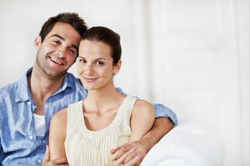Fototapeta premium Portrait, relax and smile with couple on sofa in home for bonding, support or weekend break. Happy, connection and commitment with man and woman in living room of house for marriage, space or loyalty