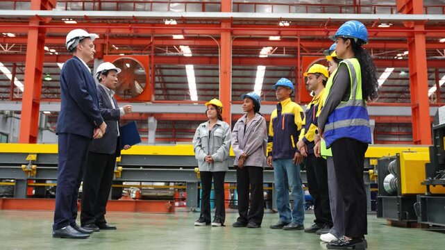 Team meeting in industrial facility engaged workers discussing safety protocols and team collaboration
