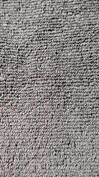 Close-up of soft towel fabric texture featuring highly detailed cotton loops and absorbent fibers. Ideal as a background, textile pattern, bathroom concept, fabric material reference, or design resour