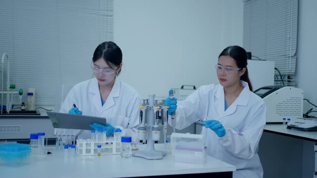 Two female scientists collaborating on research and experiments in a modern laboratory for medical development