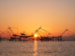 Sunrise with traditional fishing trap in Pak Pra village, Phatthalung, Thailand © lkunl