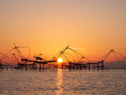 Sunrise with traditional fishing trap in Pak Pra village, Phatthalung, Thailand