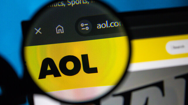 Magnifying glass over AOL.com website on a computer screen with pixelated detail