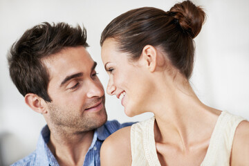 Obraz premium Relax, couple and smile with love in home for bonding together, healthy marriage and conversation. Care, support and happy people with talk in house for connection, commitment and relationship trust