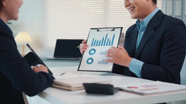 Businessman presenting financial data chart during business meeting with colleague in the office
