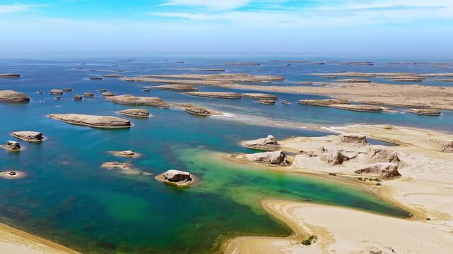 Aerial drone shot of water yardang landforms surrounded by turquoise water in the Qaidam Basin, Qinghai, China