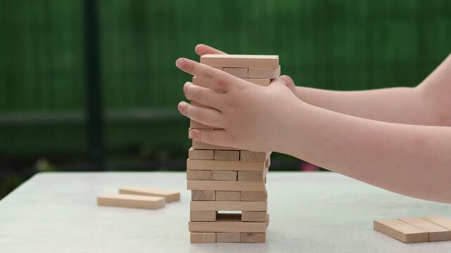 Board game. Wooden blocks. Hands. Slow motion video. High quality 4k footage