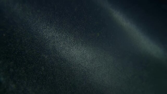 Close up of microplastics in water showing tiny particles