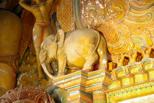 Traditional elephant sculpture and intricate wall carvings inside Wewurukannala Vihara temple