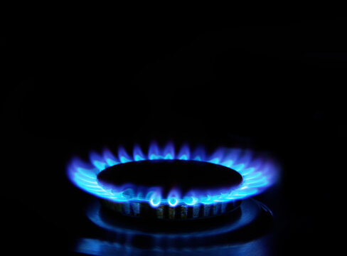 Falames of gas stove in the dark. kitchen gas cooker with burning fire propane gas