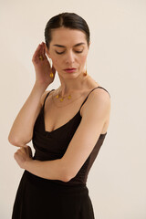 Obraz premium Chic woman in elegant attire showcases timeless fashion and graceful style in a serene setting