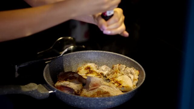 Chef Seasoning Meat With Pepper Mill Grinder Frying Pieces In Hot Pan. Cooking Dinner Meal 