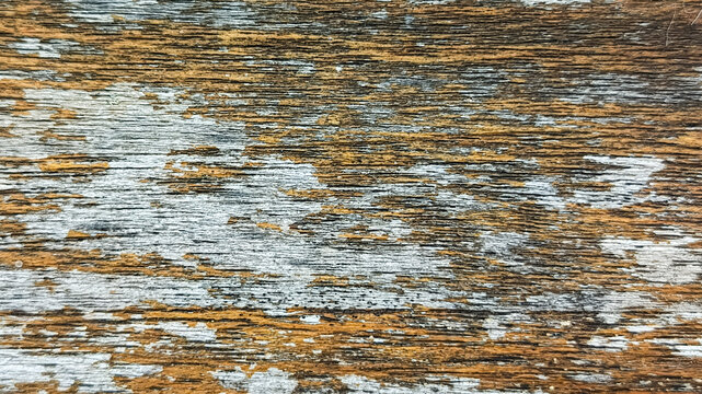 Abstract texture of old weathered wood surface with peeling paint and rust colors