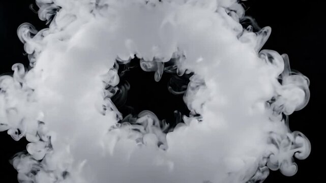 Slow motion expansion of white smoke ring against black background, creating a dynamic swirling vortex with copy space for text