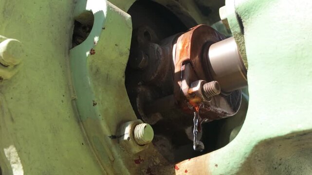 Water leaking from the gland packing of a rotating shaft on industrial machinery