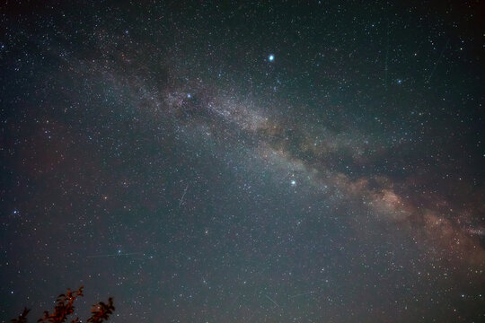Summer Milky Way stars and landscape scenery silhouettes.