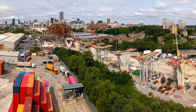 Aerial view of a Birmingham cityscape skyline with the new HS2 rail line being constructed through industrial sites
