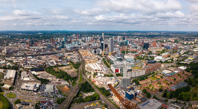 Aerial panorama view of Birmingham city centre cityscape skyline with HS2 next to modern retail and University buildings, UK