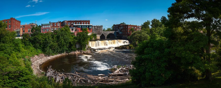 Middlebury Falls, pine tree forest, riverfront park, and historic architecture high on Main Street along the Otter Creek in Middlebury, Vermont, USA, a classic panoramic summer landsape of New England