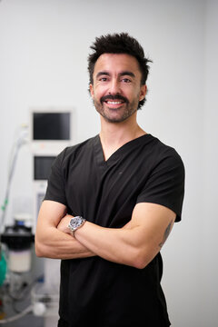 Veterinarian doctor smiling in black scrubs at clinic