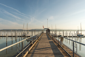 Obraz premium Wooden pier in the harbor of Iznang, Hoeri peninsula, Lake Constance, Baden-Wuerttemberg, Germany