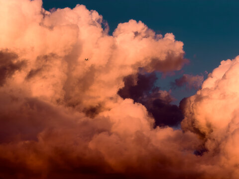 Airplane flying in daydream sunset sky 