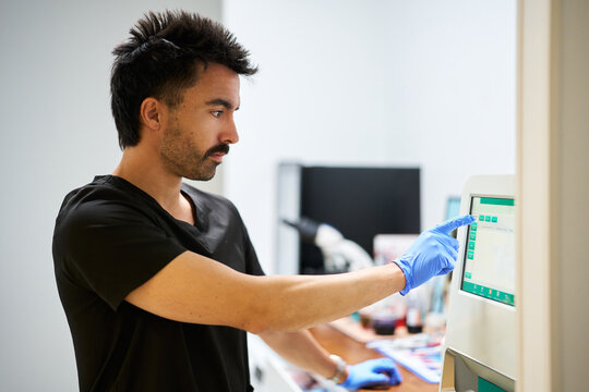 Veterinarian using medical equipment in modern clinic