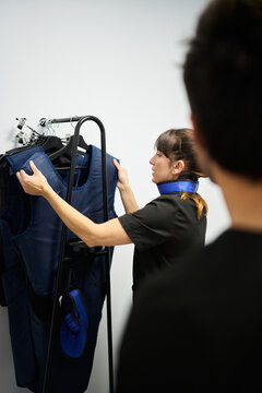 Veterinarian preparing radiology protective aprons and thyroid shield