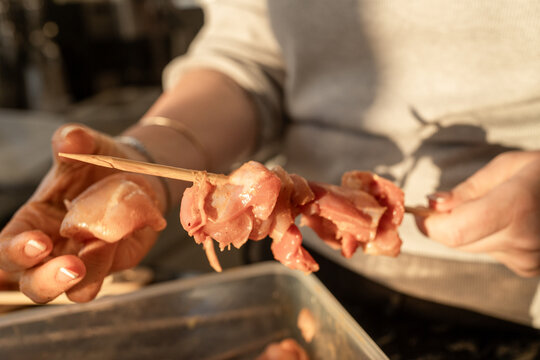 Preparing Meat Skewers for Cooking at a Market