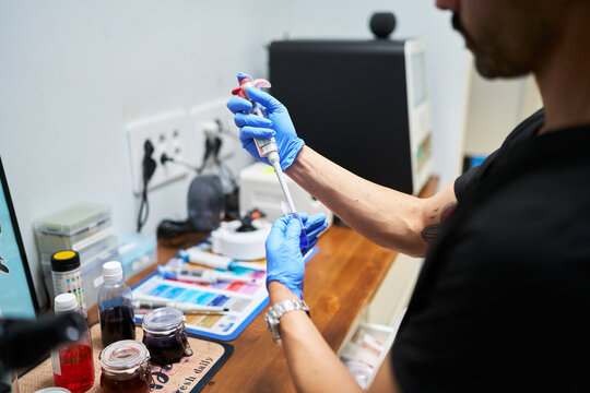 Veterinarian scientist doing lab work with pipette and sample