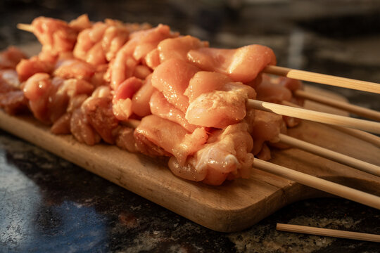 Grilled Chicken Skewers Ready for Cooking at a Barbecue Event