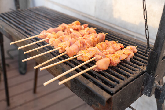 Grilling Chicken Skewers on Metal Grill in Outdoor Space