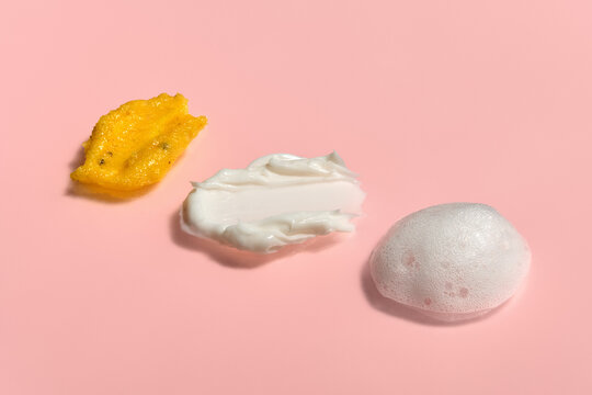 Different Shapes and Textures of Skincare Products on Pink Background