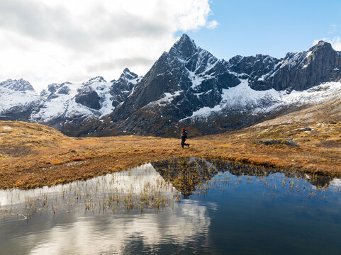Snowy mountain peaks reflected in a calm alpine lake