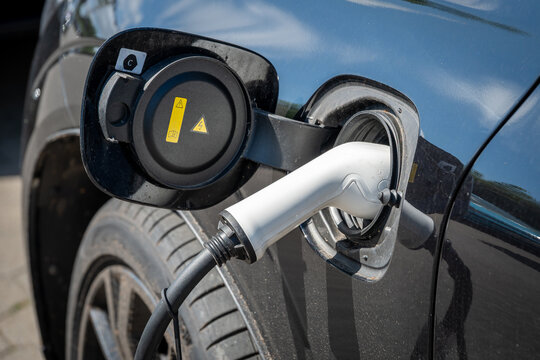 Electric vehicle with white charging plug and cable