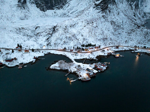Snowy coastal village on a mountain fjord