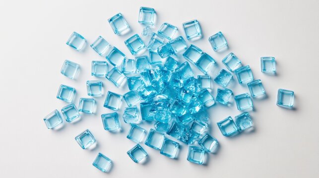 A pile of light blue ice cubes scattered on a white background.