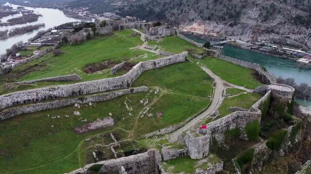 Drone video of Rozafa Castle. Albanian flag. Shkoder, Albania.