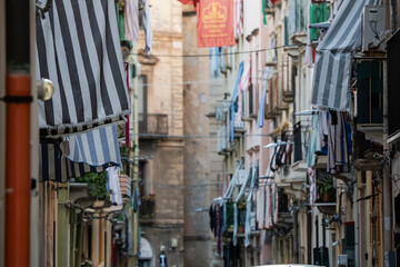 Fototapeta premium Typical striped awnings for sun protection, Casalicchio neighborhood street, Trapani, Sicily, Italy, Europe