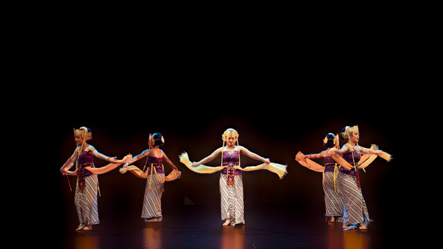 Symmetrical Traditional Dancers Stretching Flowing Ceremonial Scarves