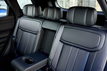Fototapeta premium luxurious modern car interior with leather seats and center console in vehicle cabin perspective, showcasing high-end design and materials in a serene and dynamic setting.