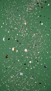 Green backdrop filled with floating, sparkling fragments