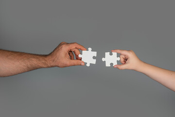 Puzzle create teamwork solution concept. Puzzle assembly shows planning and strategy. Human hands...