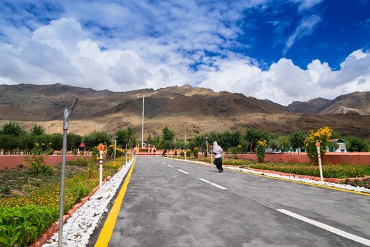 Kargil,Jammu and Kashmir, India - 01.09.2014 : Kashmiri girl child children on her way to school near Vijay Rath memorial , symbol of Indian win over Pakistan in Kargil war 1999 ,Operation Vijay.