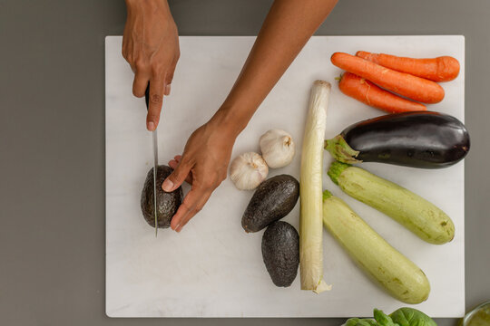 Top of view of hands slicing avocado for healthy cooking