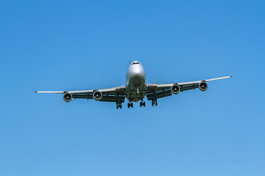 Large Passenger Airplane Landing Against Clear Blue Sky | Lądowanie dużego samolotu pasażerskiego na tle czystego, błękitnego nieba